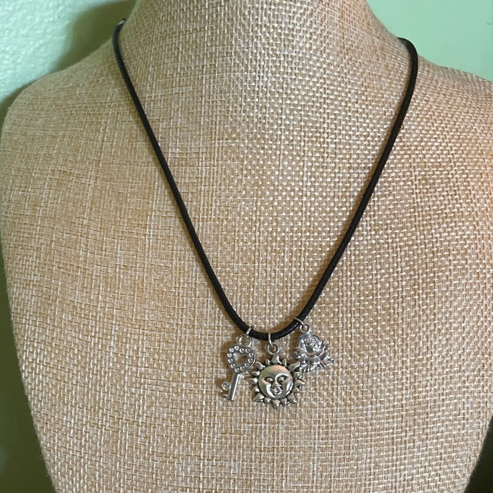 Boho necklace with silver rose, key and smiling sun pendants